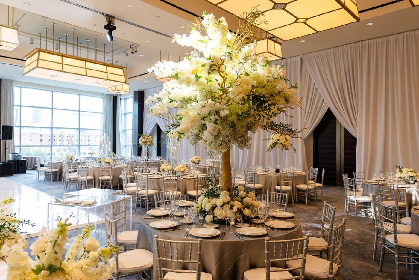 Tall tree centerpiece with white flowers at a Boston wedding