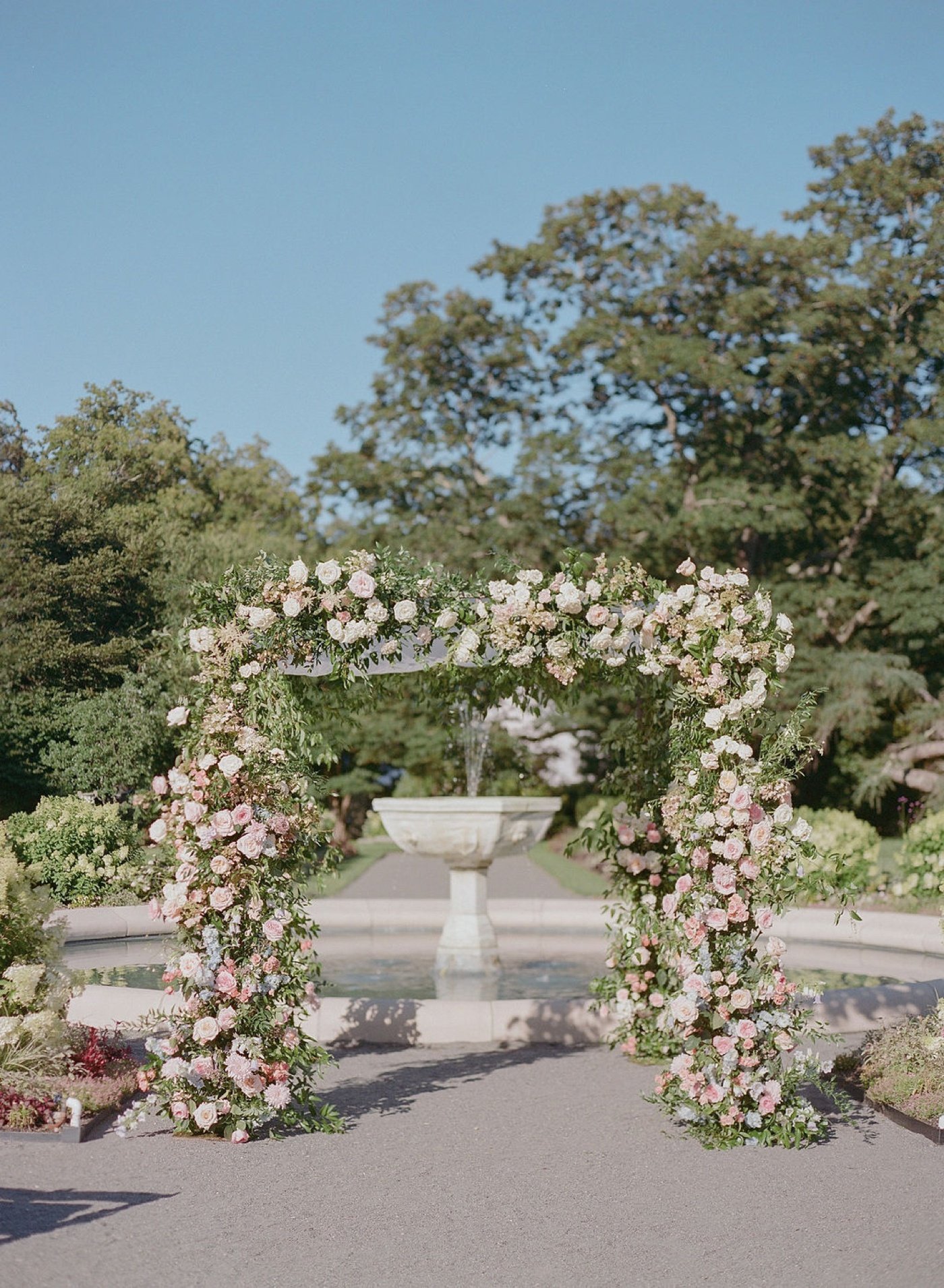 Pink and white floral wedding arch with roses and dahlias by Kerianne Nelson Flora