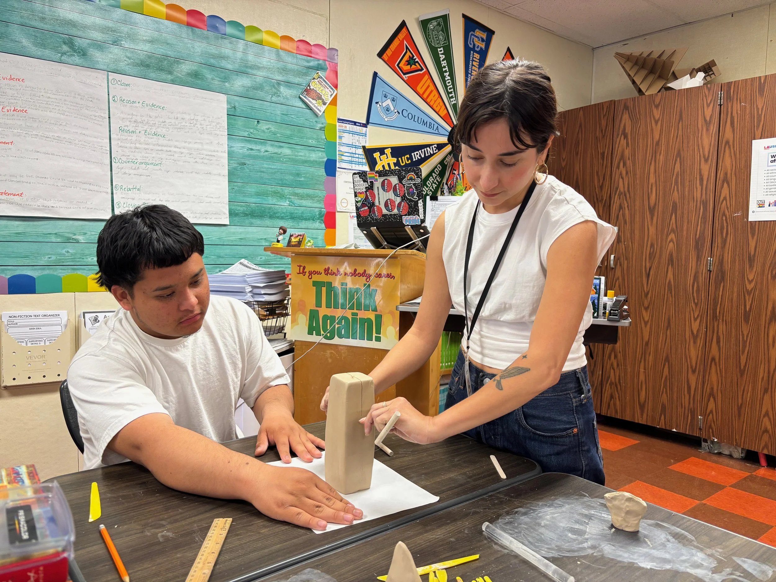 A Jack London student learns to hollow out a clay sculpture with Teaching Artist Lizette Hernandez.  