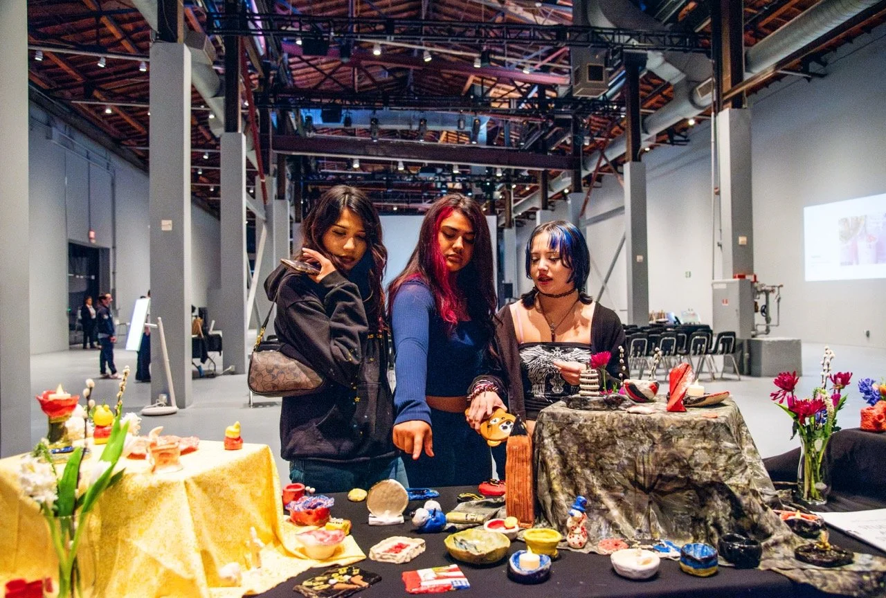  Jack London students look at their collaborative altar, displaying their clay sculptures, candles, and flowers. (Photo credit: Fabiola Lopez)