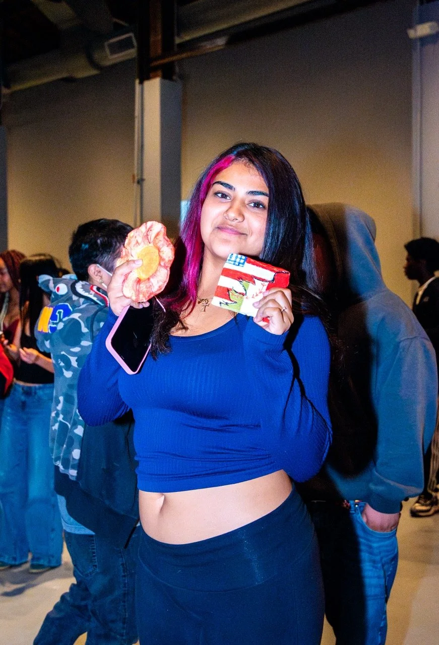 A Jack London student holds up her clay sculptures.  (Photo credit: Fabiola Lopez)
