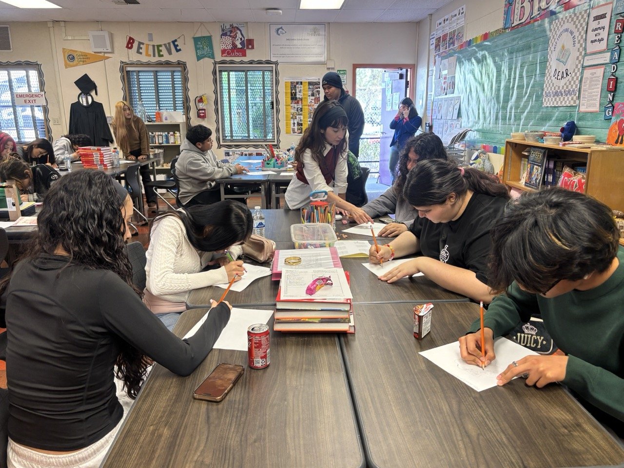 Teaching Artist Lizette Hernandez instructs students to sketch their ideas for their sculptures. 