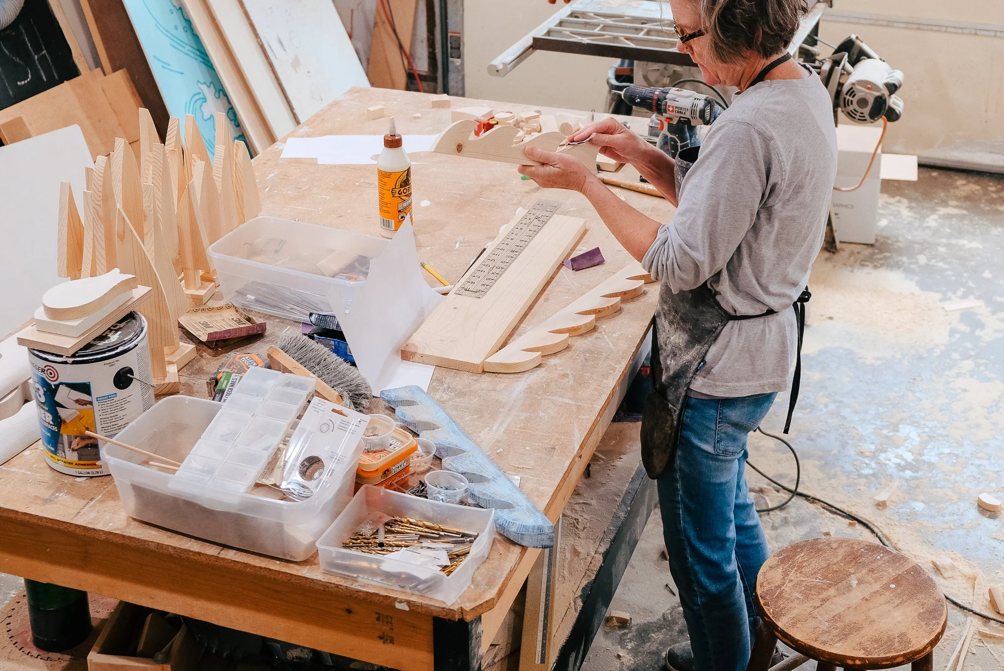 Shelly Drews Artist working in her woodshop, Fish Artist Shelly Drews, Women Wood carvers