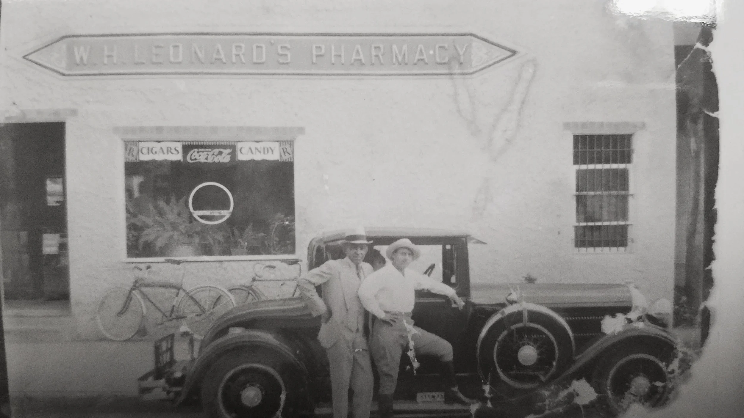 Mr & Mrs Leonards, in front of their pharmacy