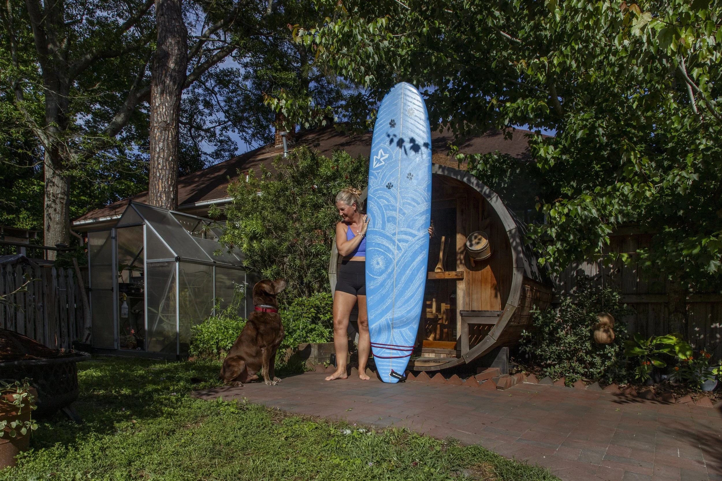 Her dog, Chaco, looks to Michi awaiting a possible treat in her backyard