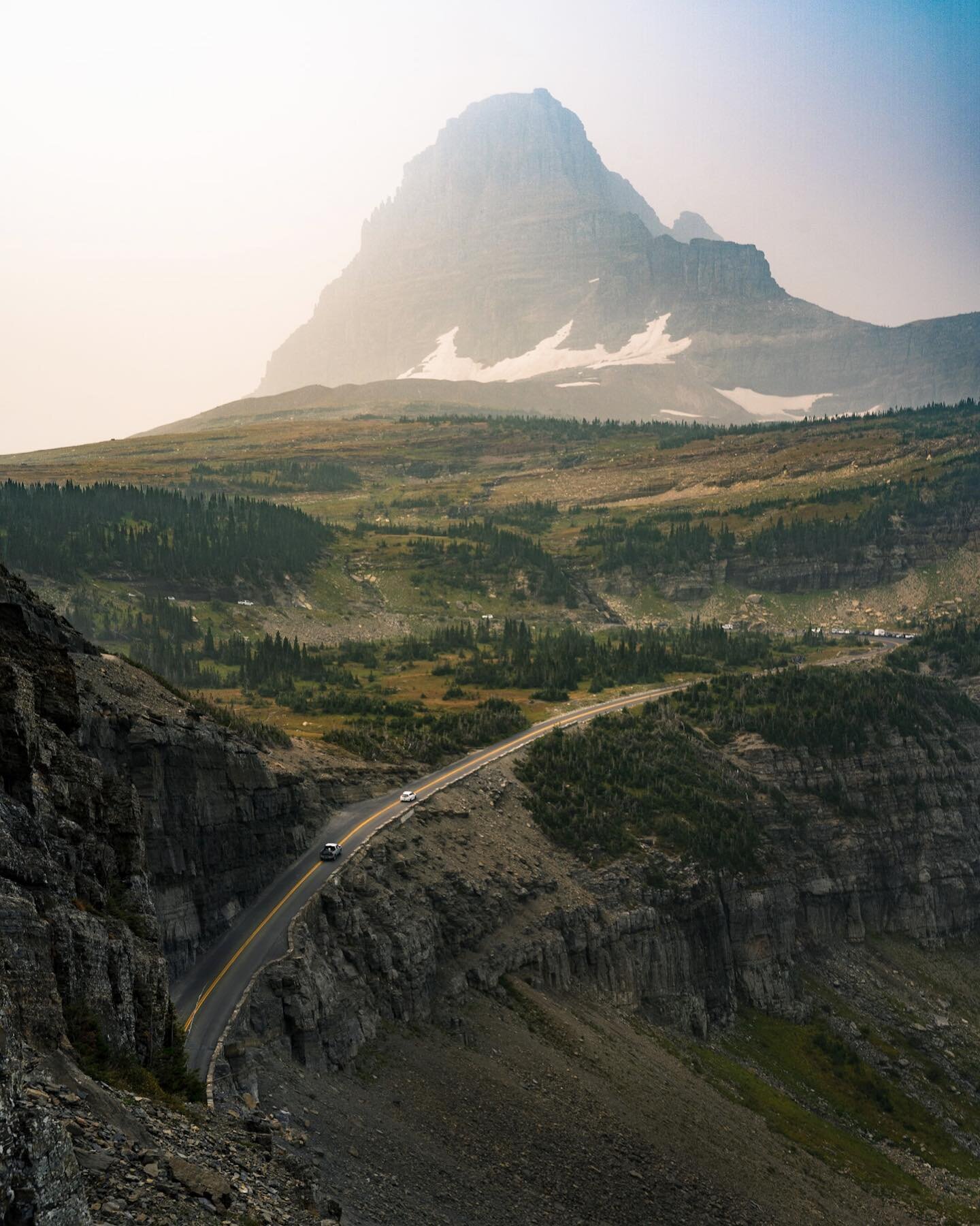 Glacier National Park was great, but wildfire smoke meant it was different from expected. Luckily we can see some of the views through photo editing...swipe to see our view vs. how I edited the photo! This photo brought to you by Lightroom's dehaze s