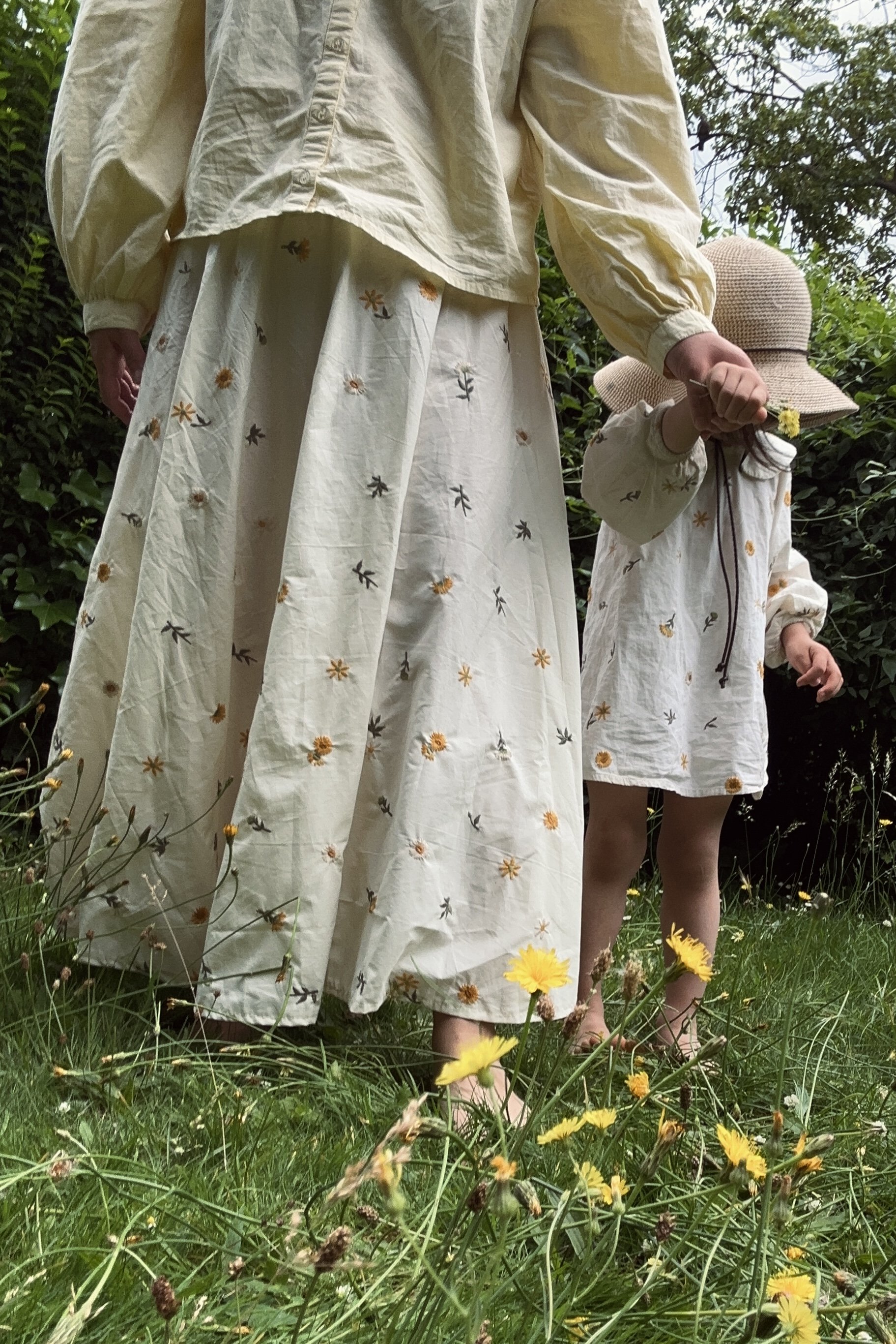 matching adult Organic Cotton white embroidered dandelion maxi skirt, with child wearing a dress made of the same fabric