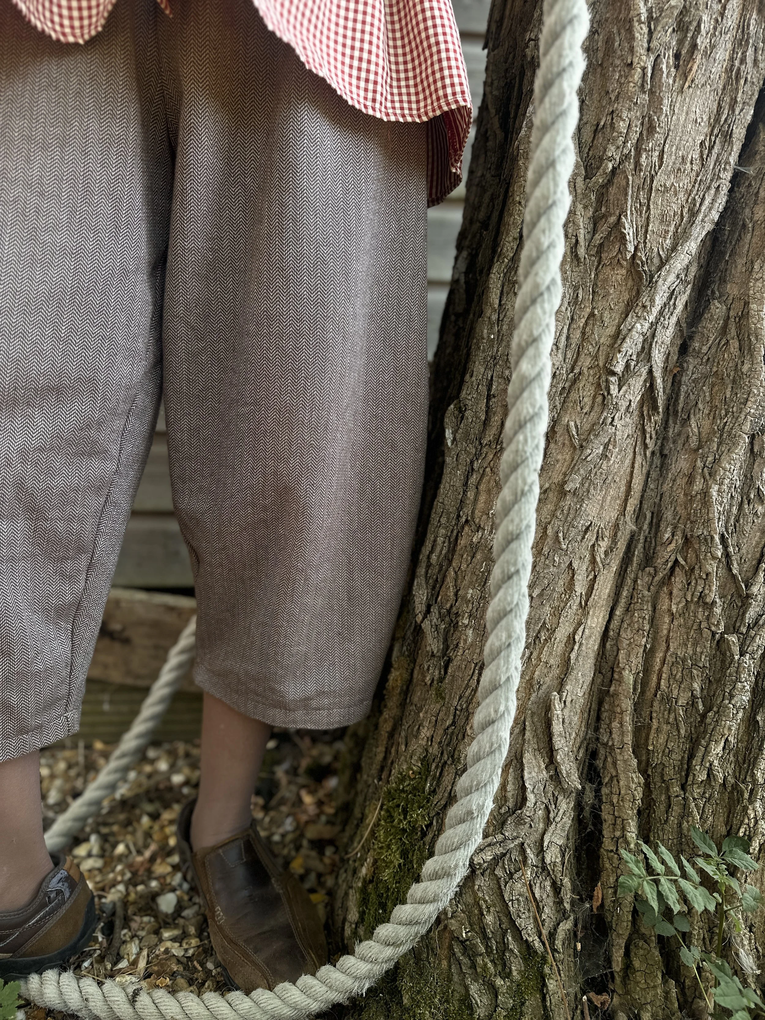 adult wearing organic cotton herringbone brown barrel leg trousers cropped style