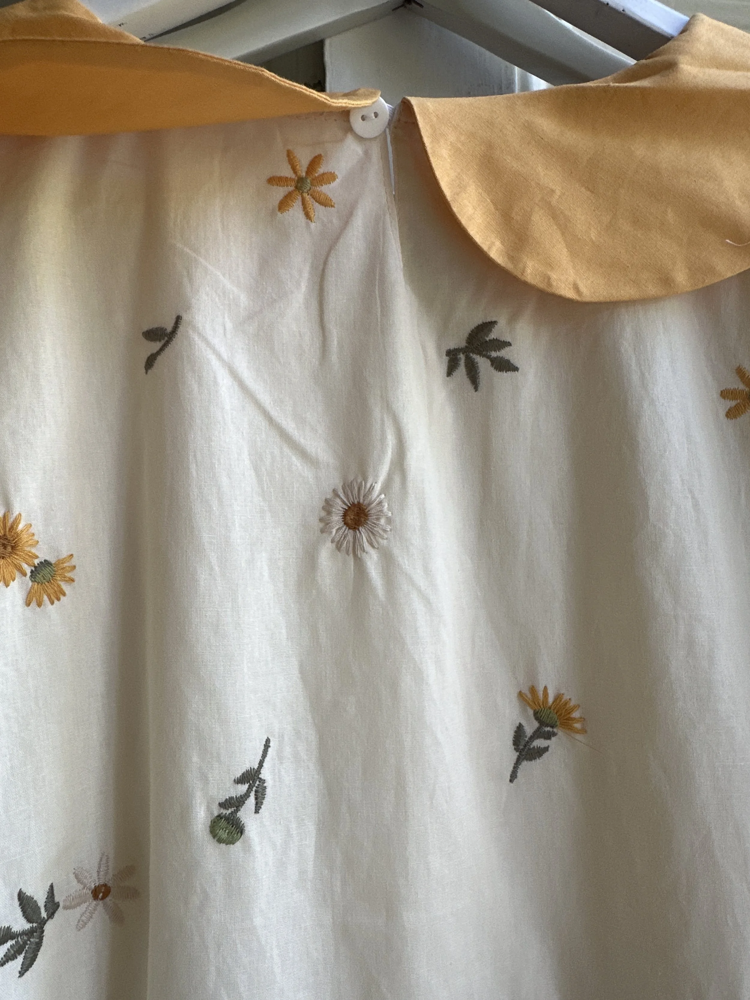 close up woman wearing Peter Pan collar maxi summer dress dandelion embroidery