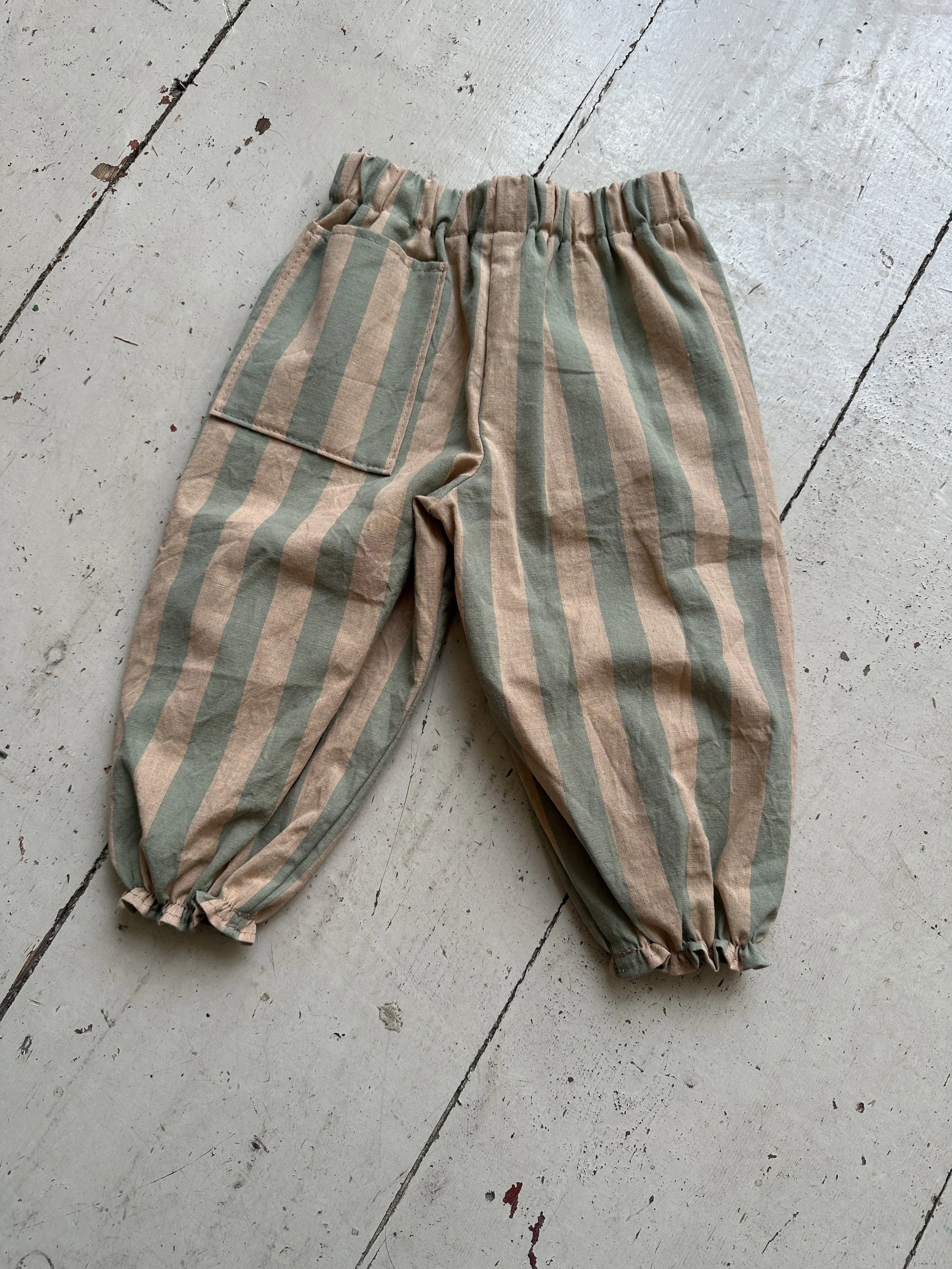 flat lay back of organic cotton wide stripe barrel trousers Sage Green & Blush Pink