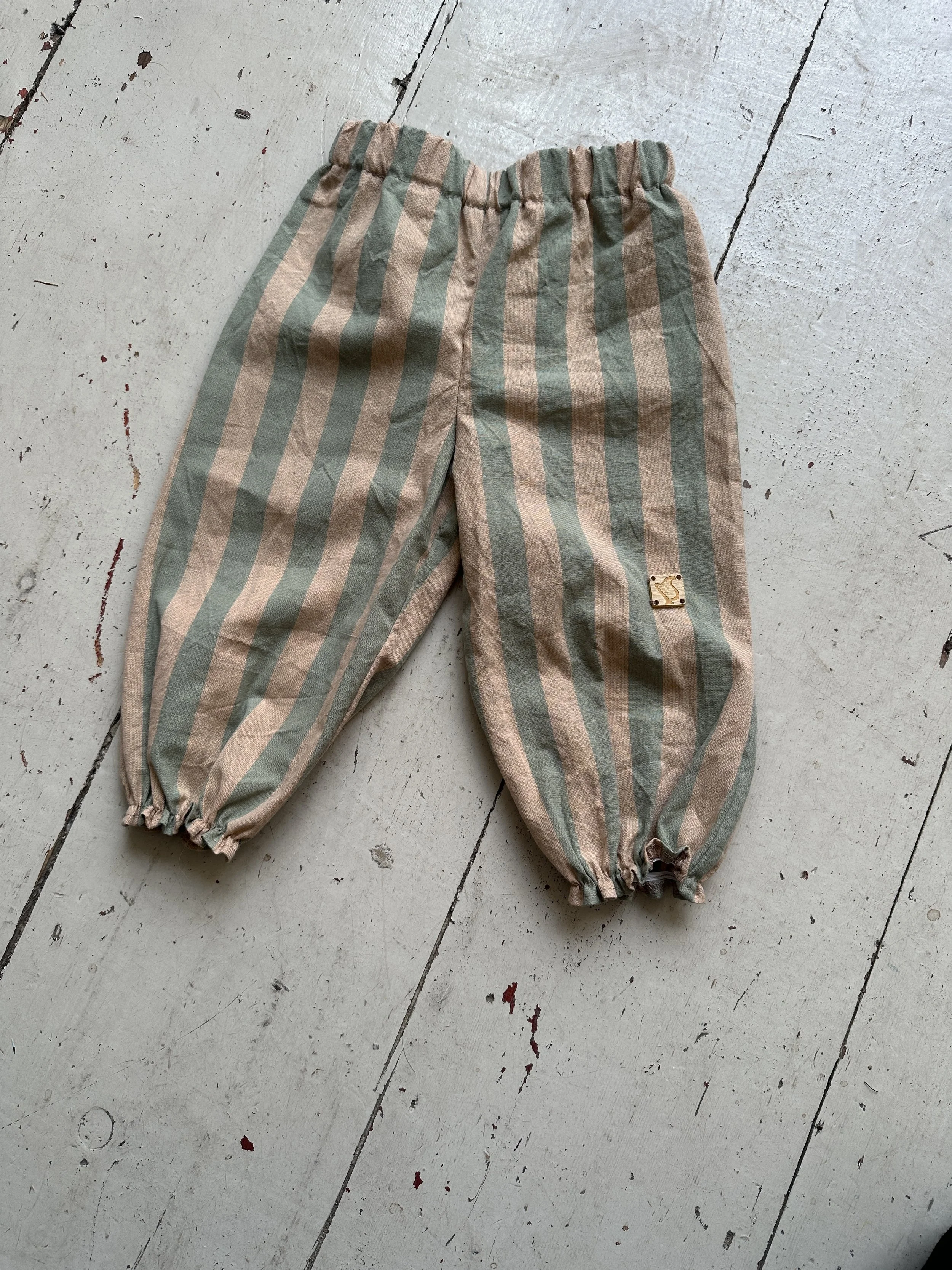 flat lay organic cotton wide stripe barrel trousers Sage Green & Blush Pink