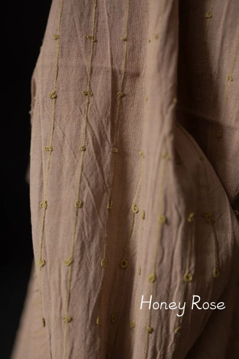 close up summer fabric light cotton soft pale pink woven with gentle yellow loops