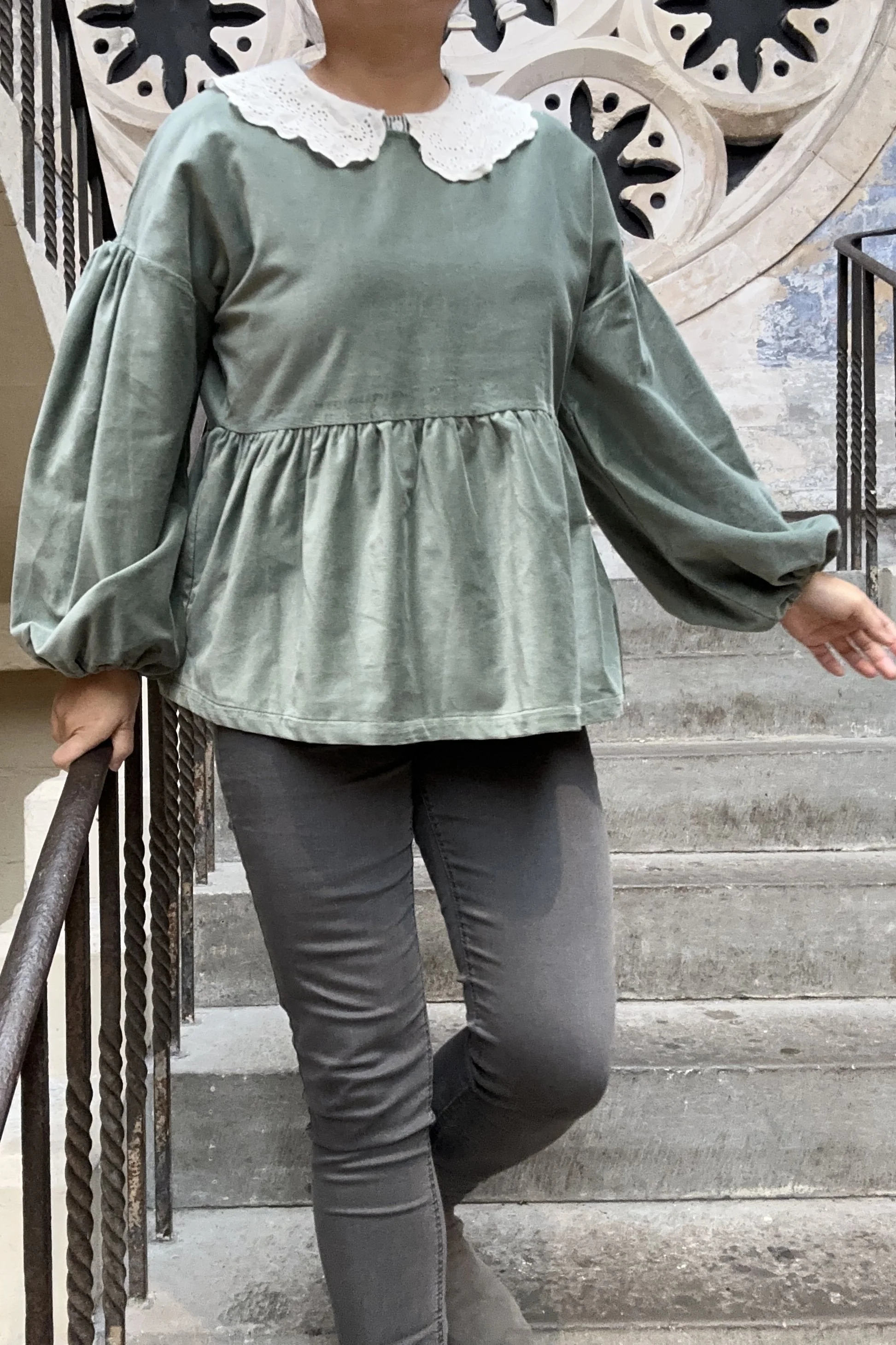 Adult wearing duck egg green-grey velvet Top, Featuring a relaxed fit, balloon sleeves, paired with grey skinny jeans