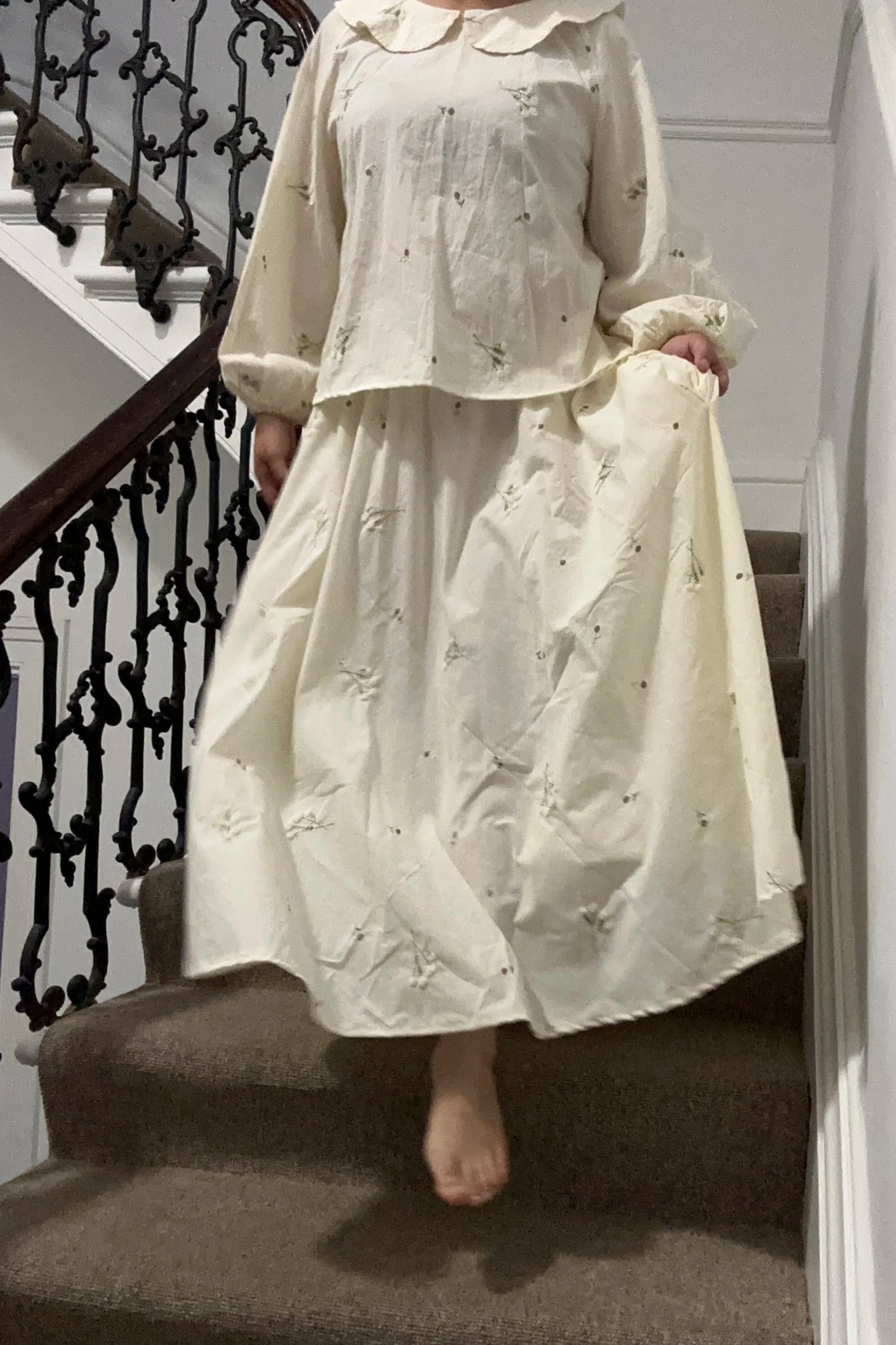 adult wearing organic cotton embroidery lace flower maxi skirt and blouse, standing on staircase