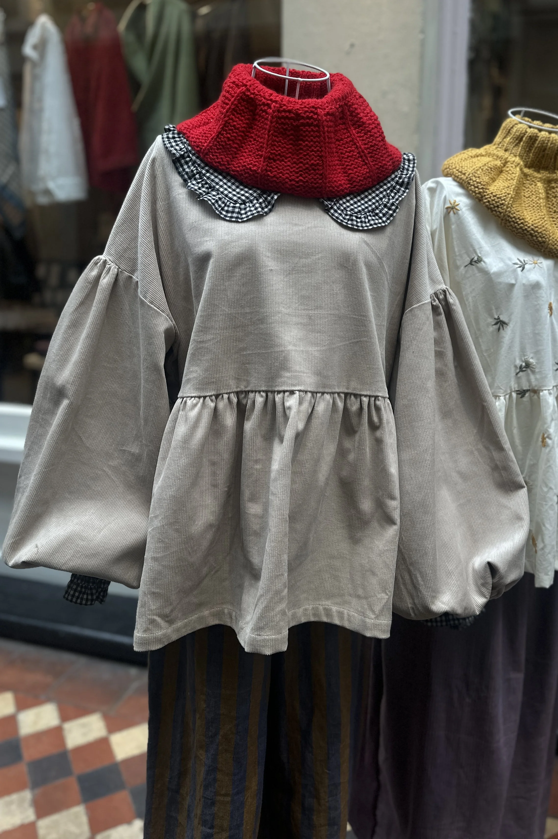 Adult Latte Corduroy Top, Featuring a relaxed fit, balloon sleeves, on mannequin, paired with hand-knitted neck-warmer