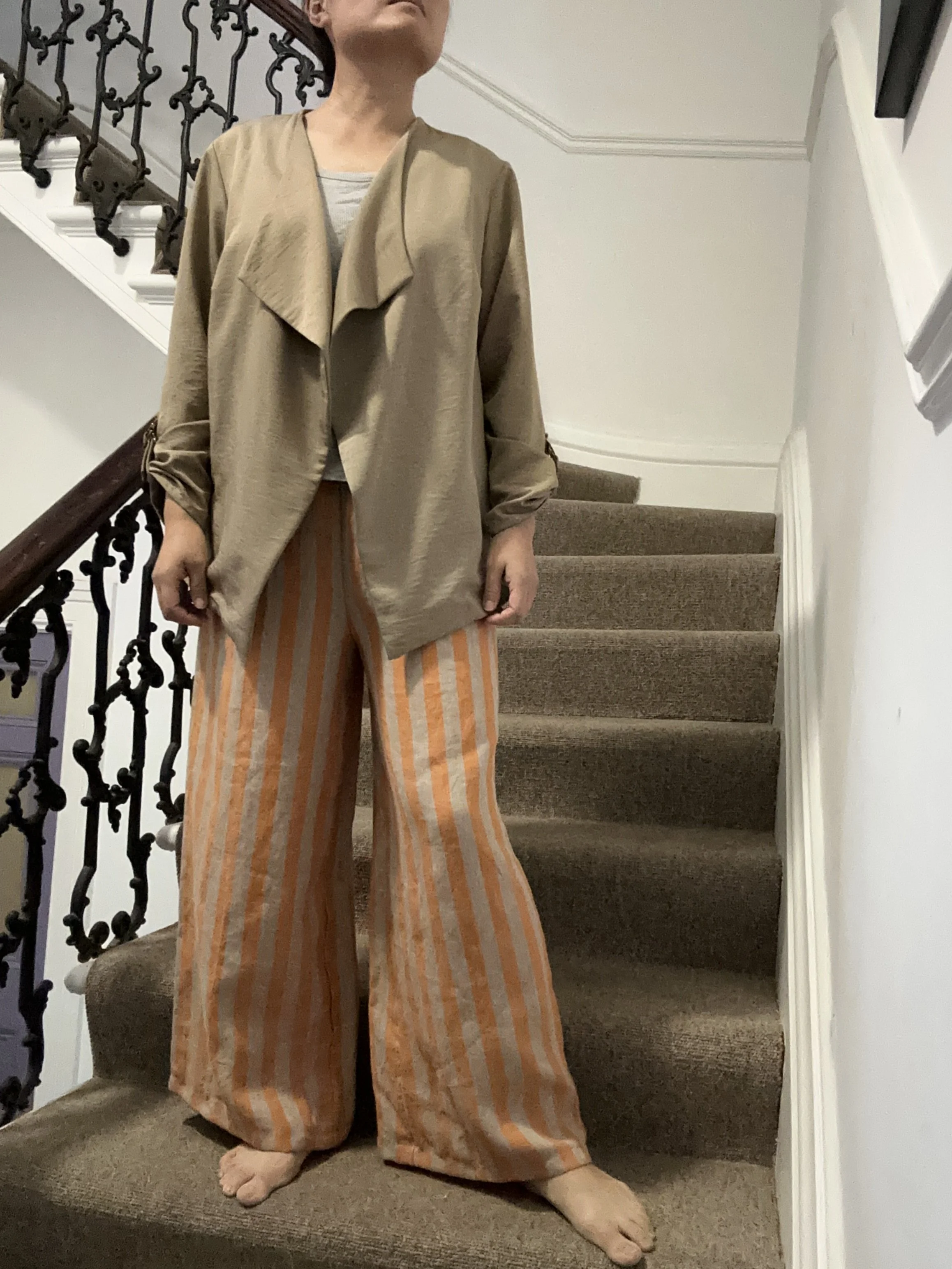 Adult wearing Wide Leg Linen Trousers – Apricot & Beige Stripe, beige jacket