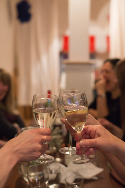Event photography London: table of guests raising glasses in cheers