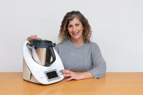 Picture of woman with grey jumper and kitchen mixer at London brand photography session