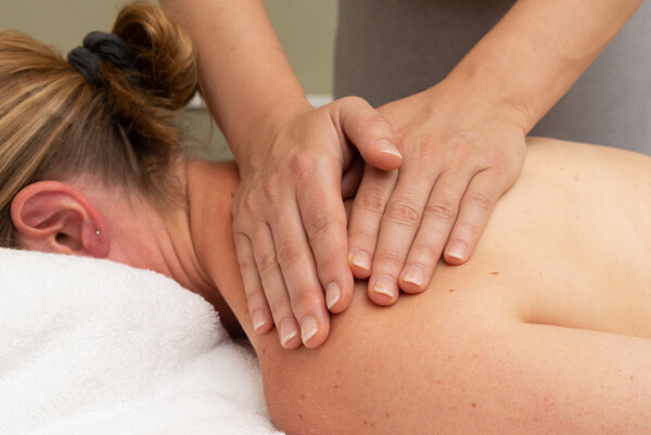 Brand photography Bromley London: hands massaging woman's back