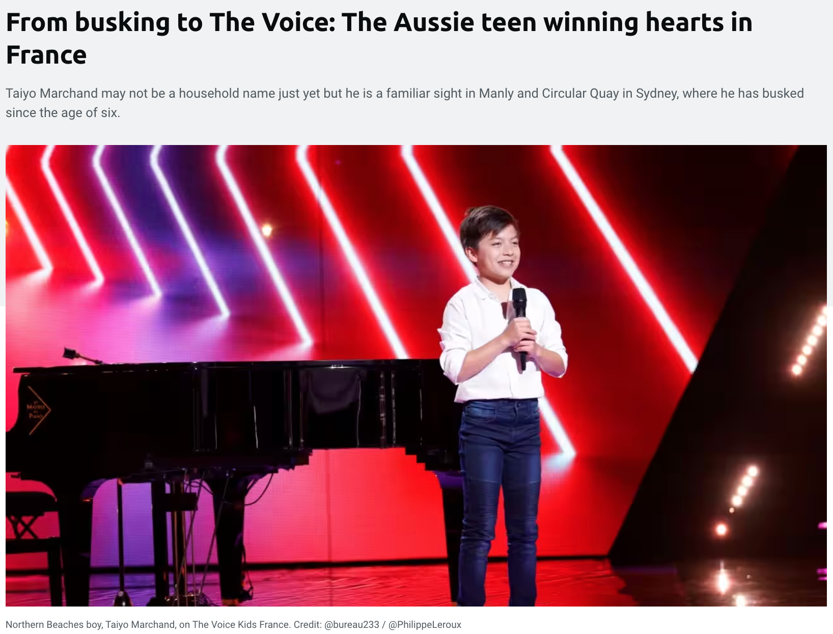 Taiyo Marchand, A young boy standing on a stage in front of a colorful, neon-lit background, holding a microphone, with a grand piano beside him.