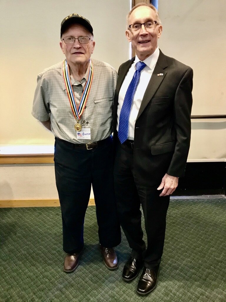  Burnie Jarvis, a member of the KWVA Oregon Trail Chapter, proudly displays the Ambassador for Peace medal presented by Greg Caldwell, honorary consul. 