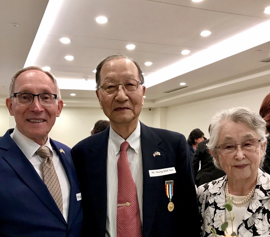  Young Mok Yun and his wife Moon Cha visit with Greg Caldwell in Seattle at the Korean Consulate. Young Mok Yun is a Korean War veteran and a former member of KWVA Oregon Trail Chapter. 