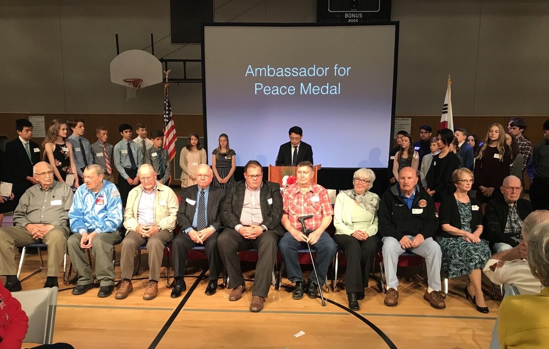  Honored Korean War veterans and family members receive the Ambassador for Peace medal at Athey Creek Middle School. 