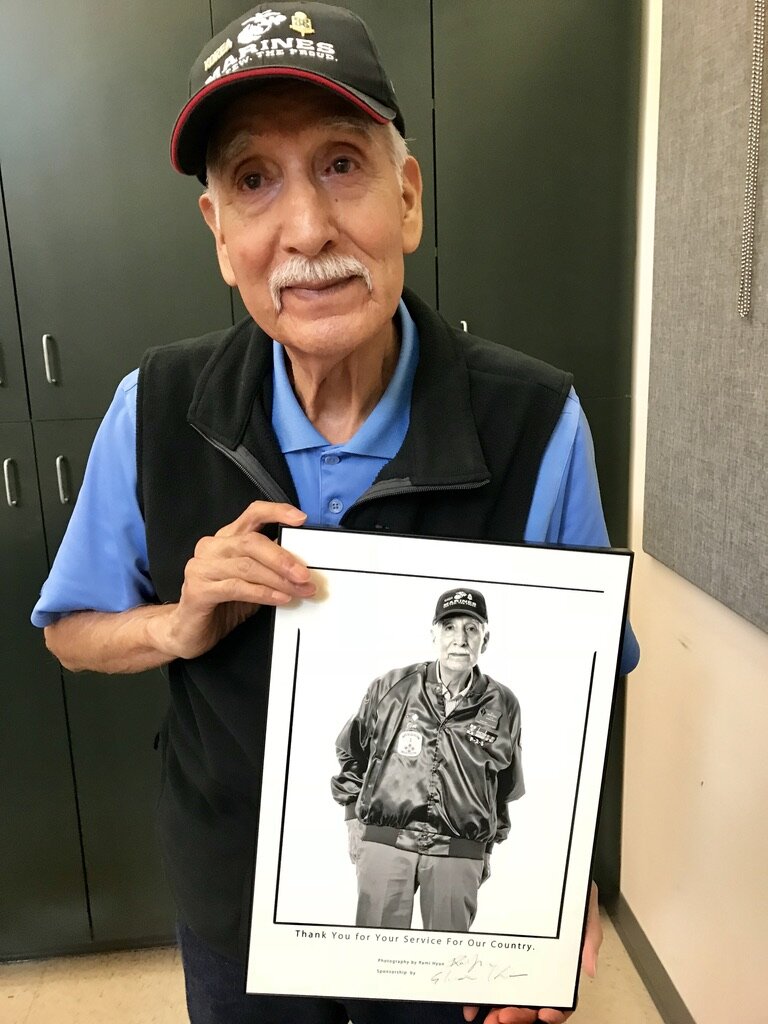  Korean War veteran Ralph James “Jim” Martinez poses proudly with his photo by Rami Hyun of Seoul, Korea. 