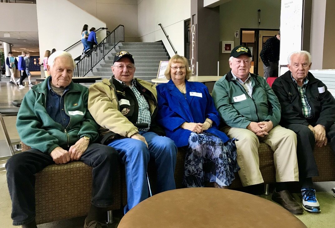  Korean War veterans—including a woman—pose before ceremonies at Athey Creek Middle School.  