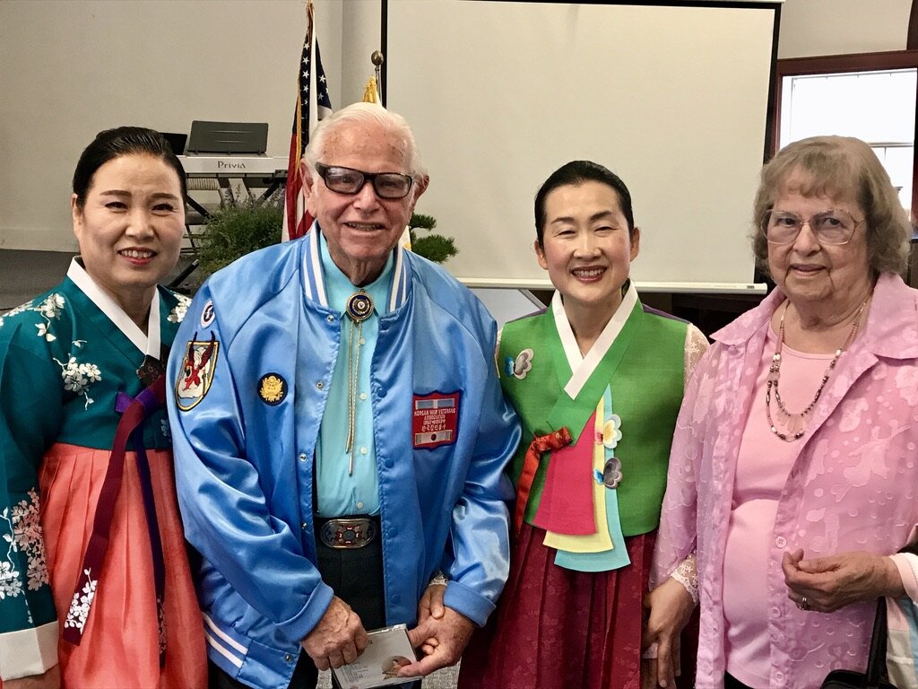  Korean War Veteran Bob Osterlund poses with his wife and two Korean performers at the annual lunch honoring veterans at the Korean Church in Salem, Oregon. 
