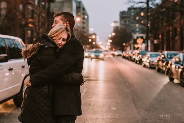 couple-embracing-one-another-in-middle-of-street.jpeg
