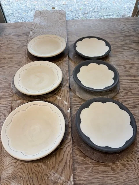 Tea plates with inlaid and applied slip before firing