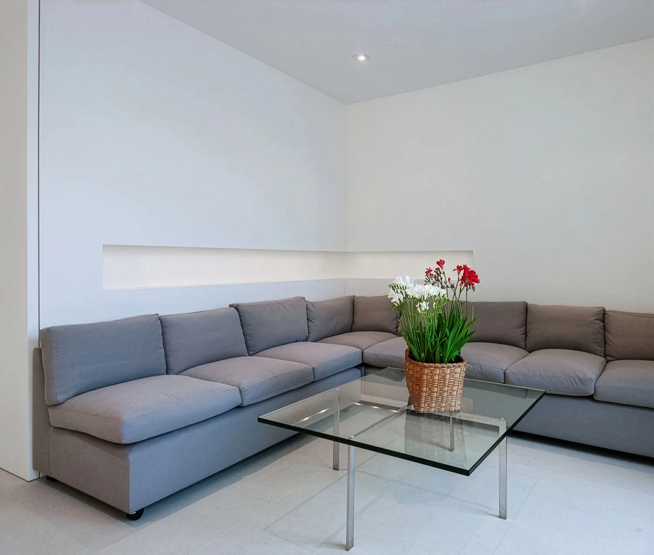 Sectional sofa with glass table in front