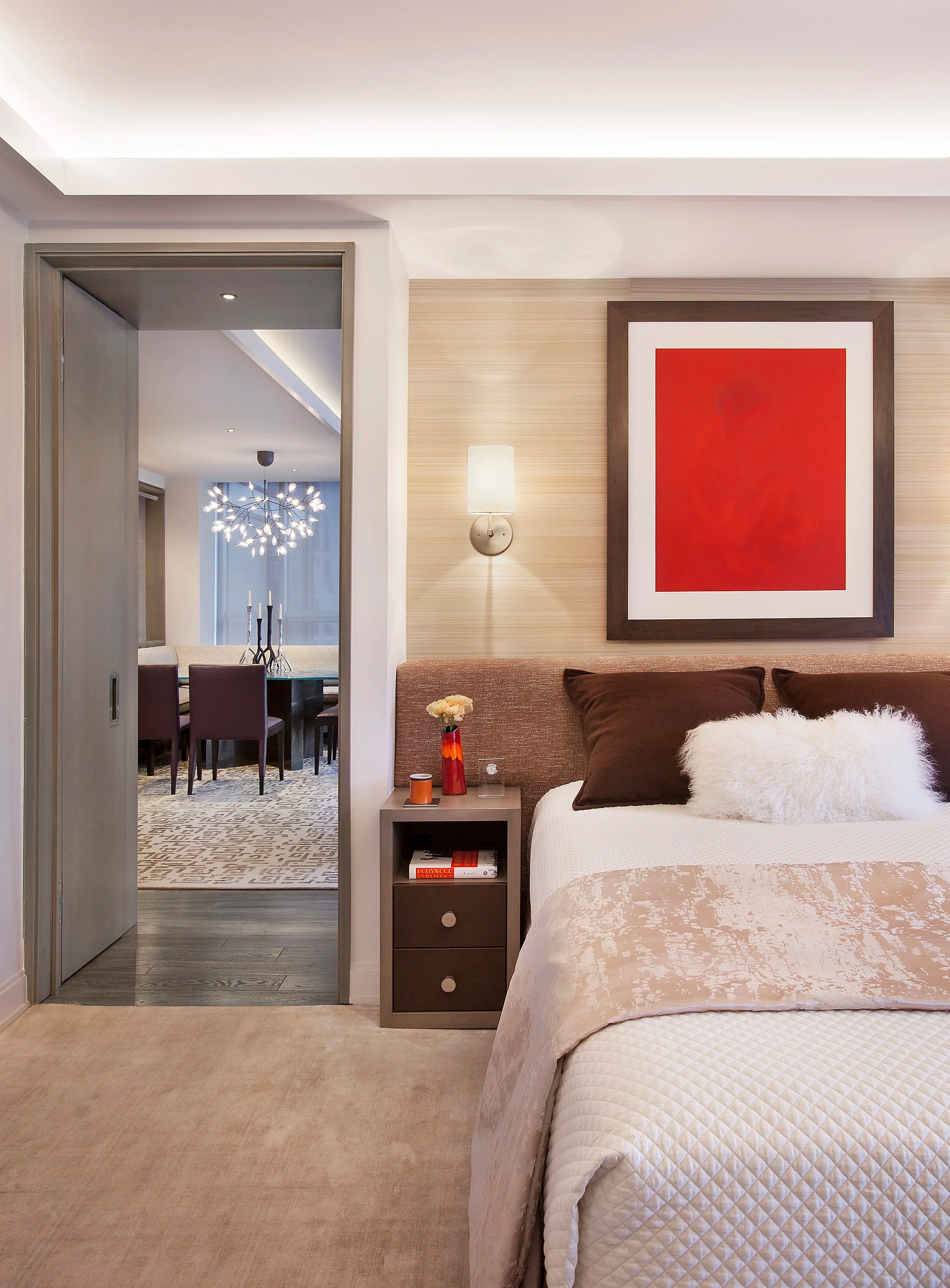 bedroom with bed with red painting overhead