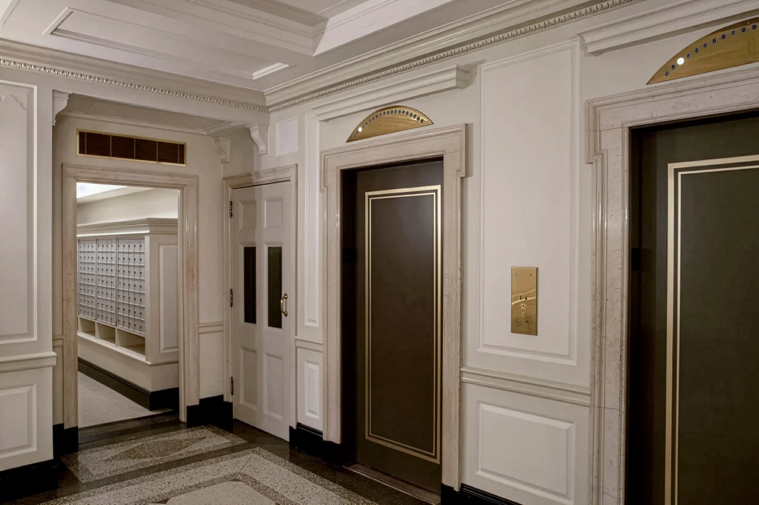 Lobby facing elevators and mail room