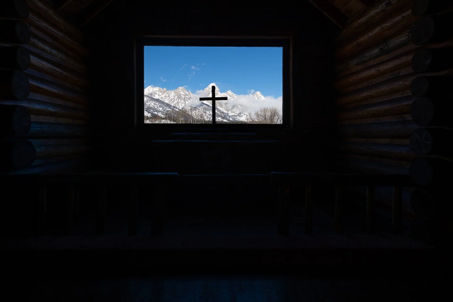 A window to something greater.

There are few places where the architecture feels like a conversation with the landscape.  Standing inside the Chapel of the Transfiguration, the world outside becomes the altar.  The silence of the logs, the silhouett