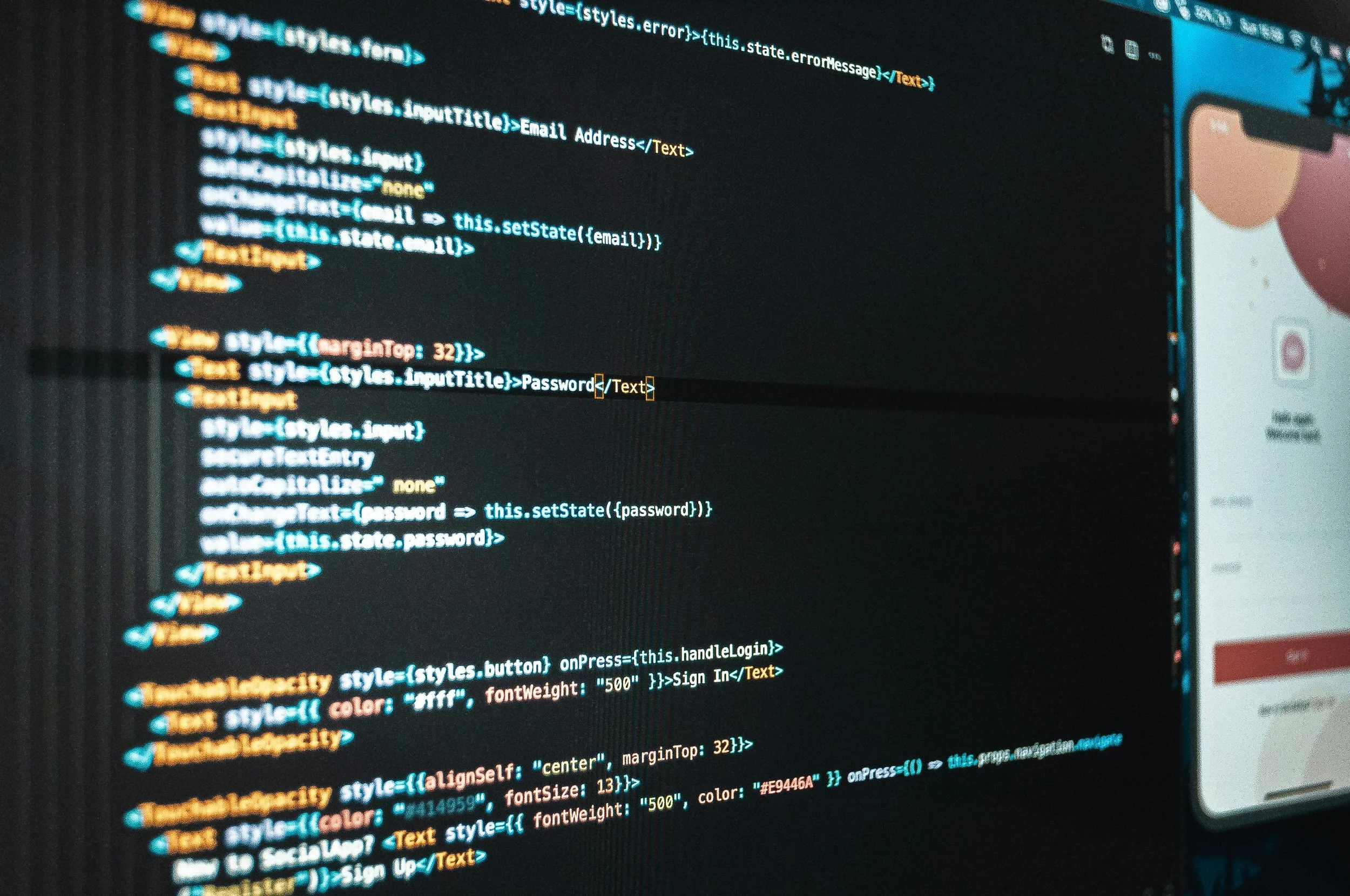 Close-up of a computer screen displaying programming code in a text editor, with part of a smartphone showing a social media app on the right side.