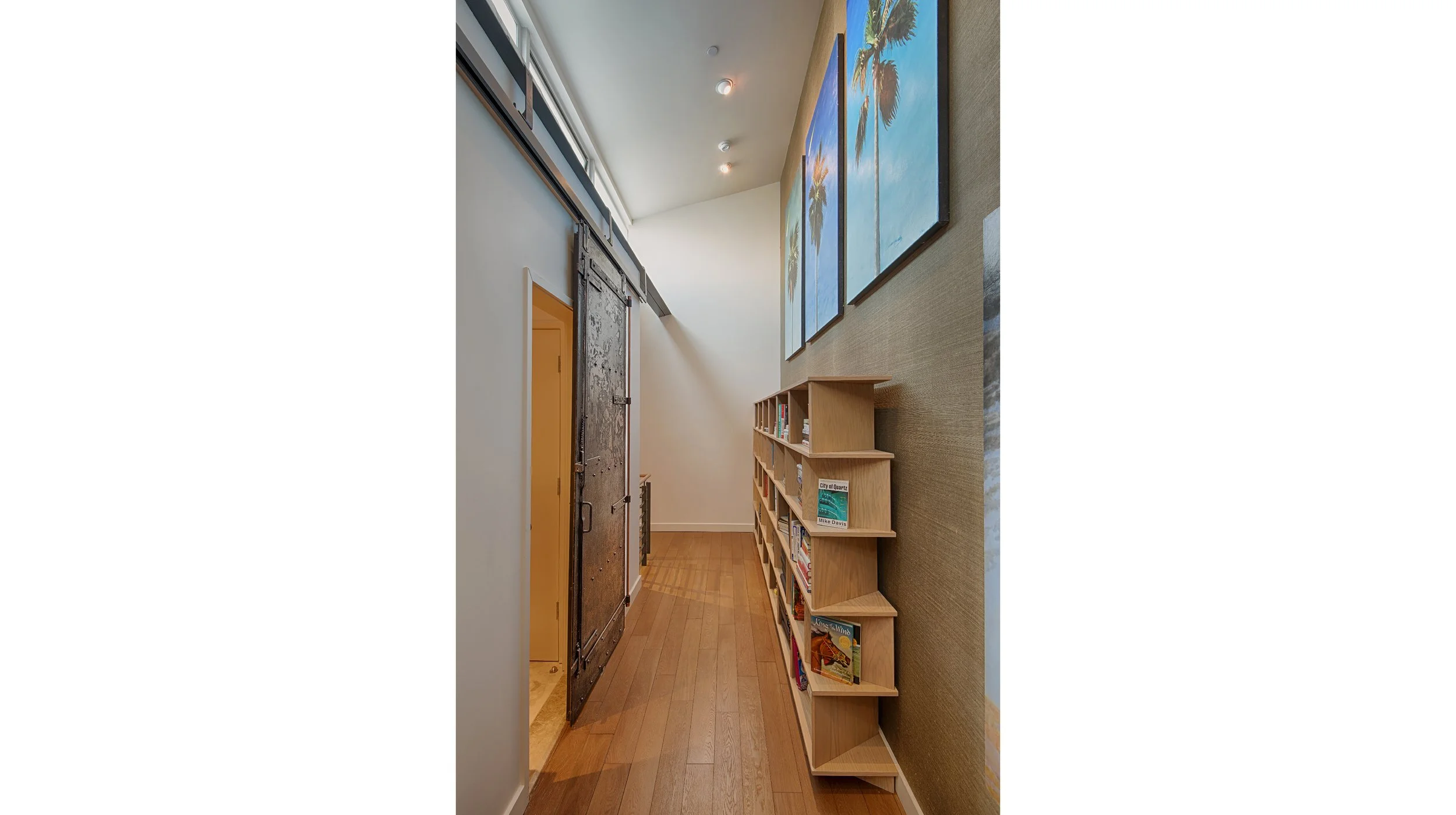 HALLWAY
Custom-made bookcase and newly installed industrial fire door from Cleveland Art, DTLA