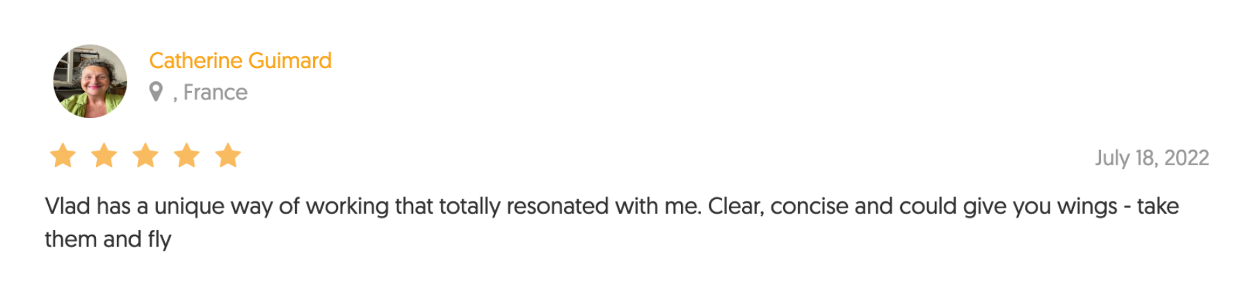 Profile review with star rating, profile picture of a woman with short curly hair smiling, text of review and date.