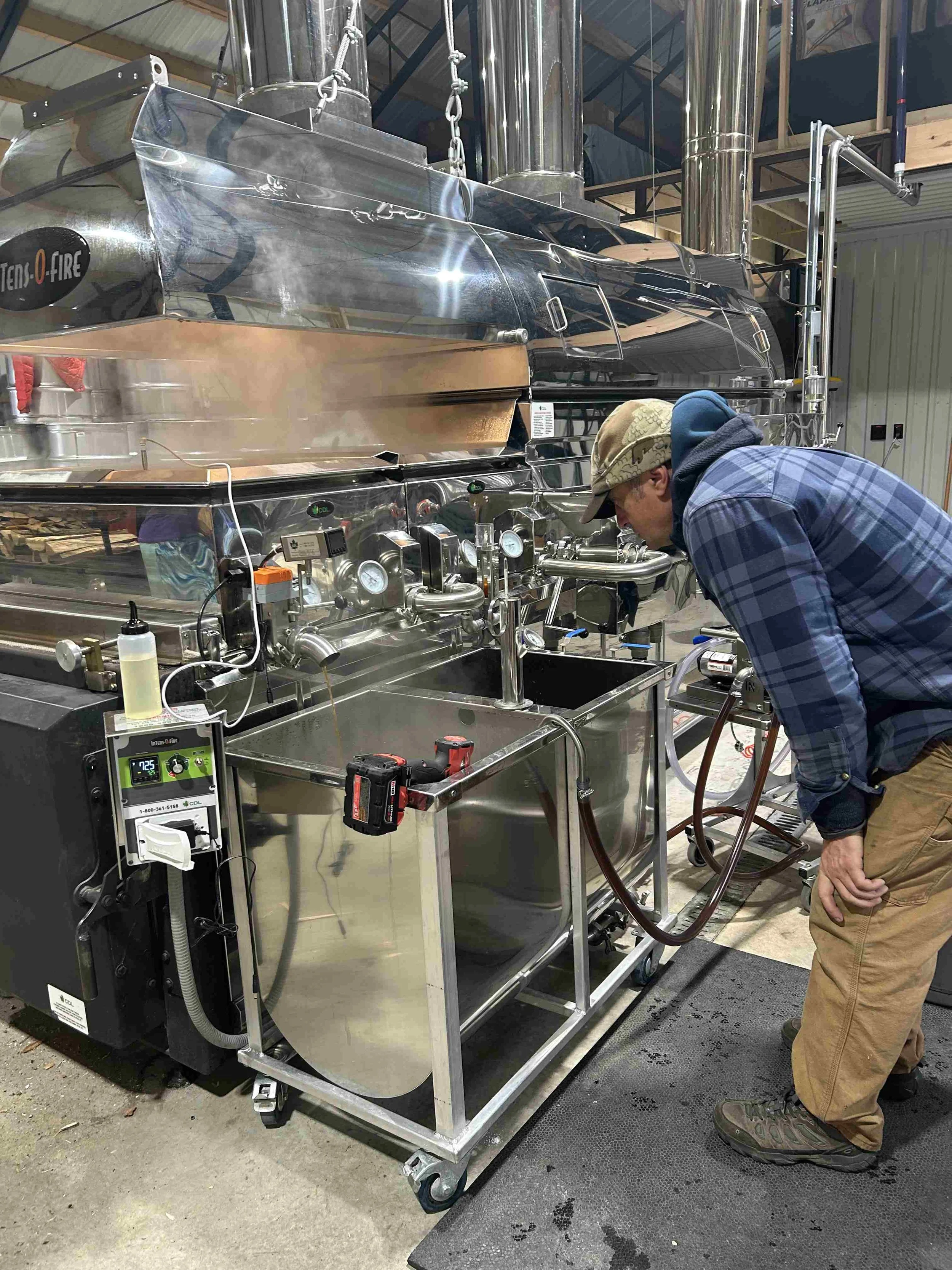 Lead sugar make Rob making sure the density of our organic maple syrup is perfect before filtering the syrup into a barrel.