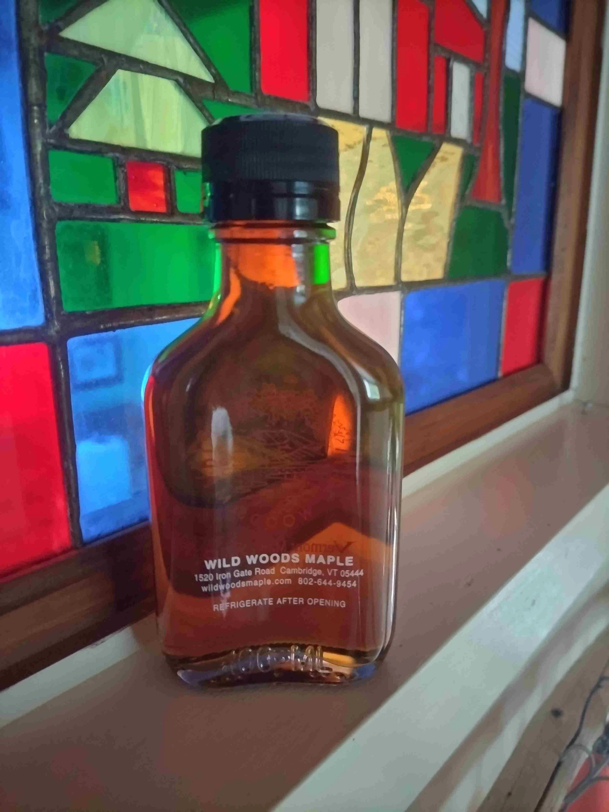 Bourbon Barrel Aged Maple Syrup back of the flask with business information