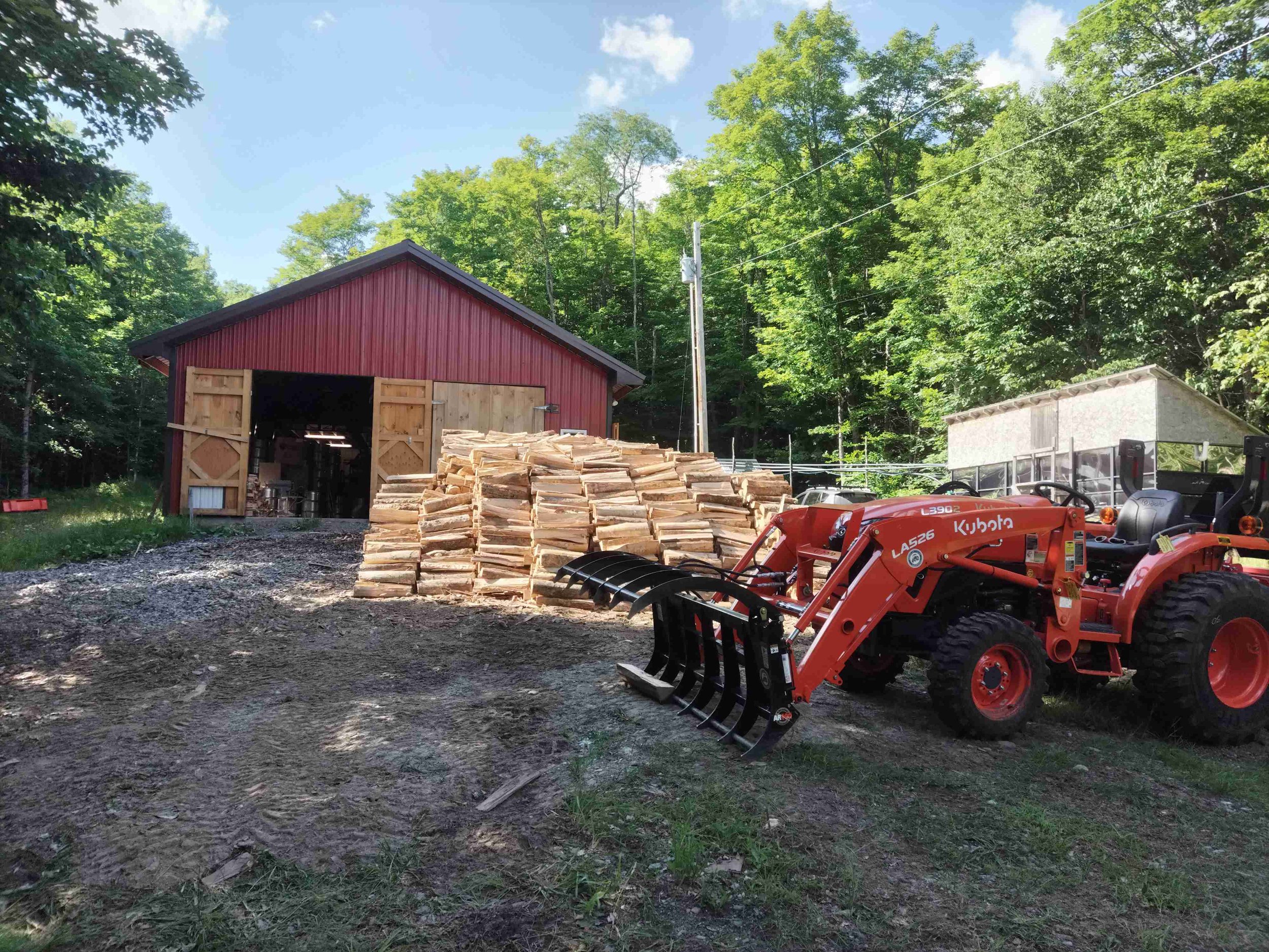 Our tractor in front of our sugar house where we make our organic award winning maple syrup.