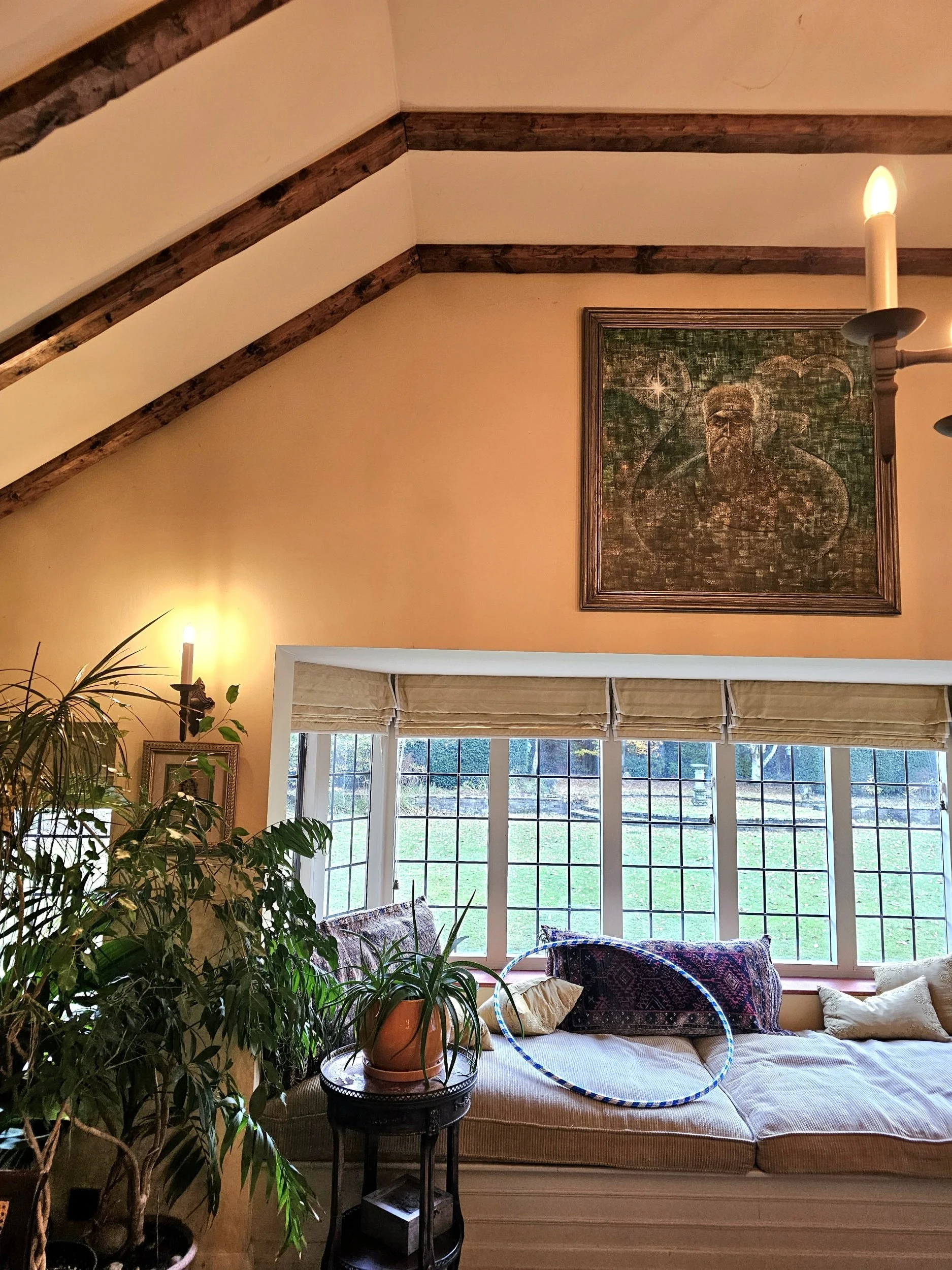 A living room with painting hung high