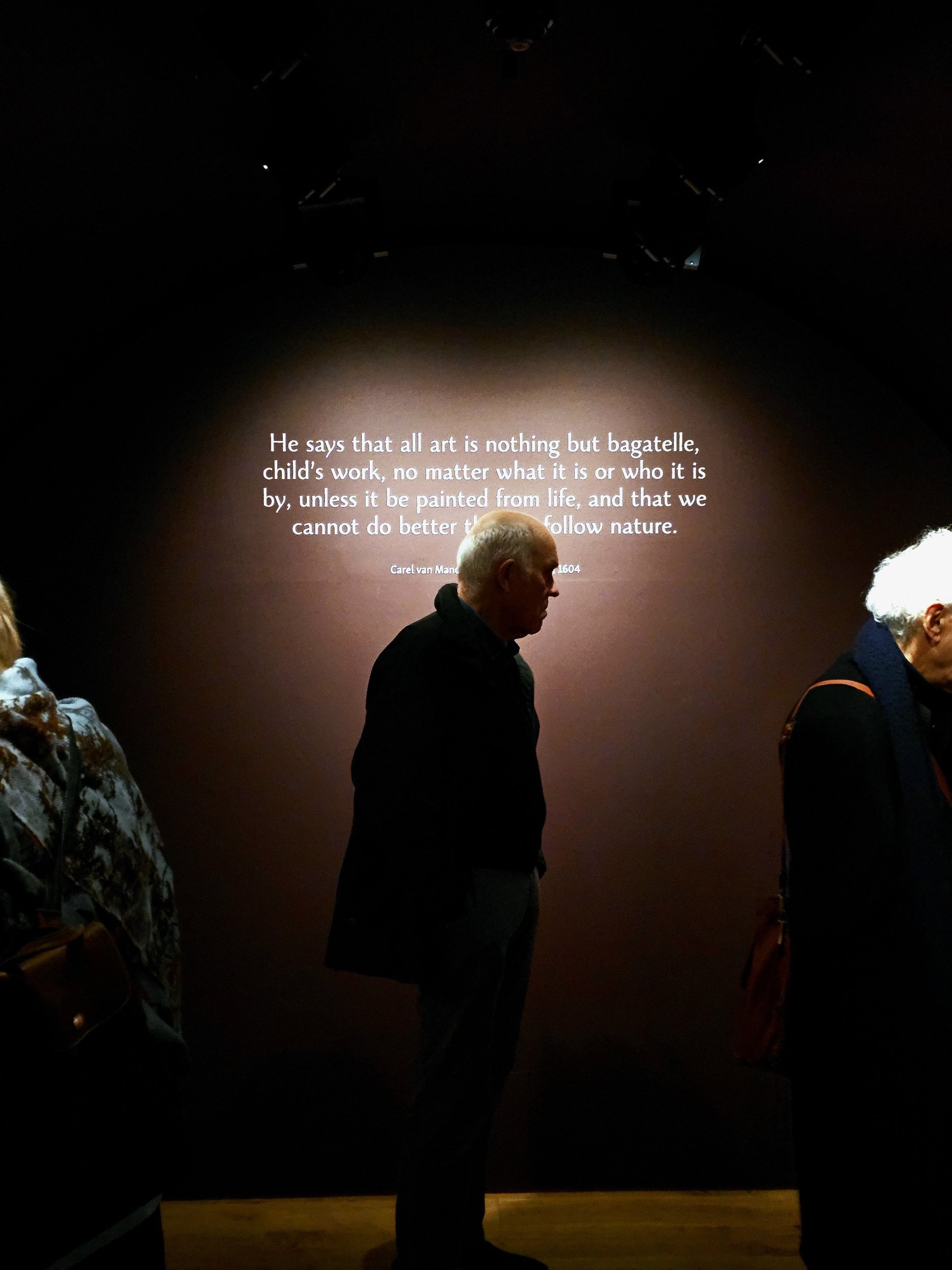 Man standing in front of quote on a wall