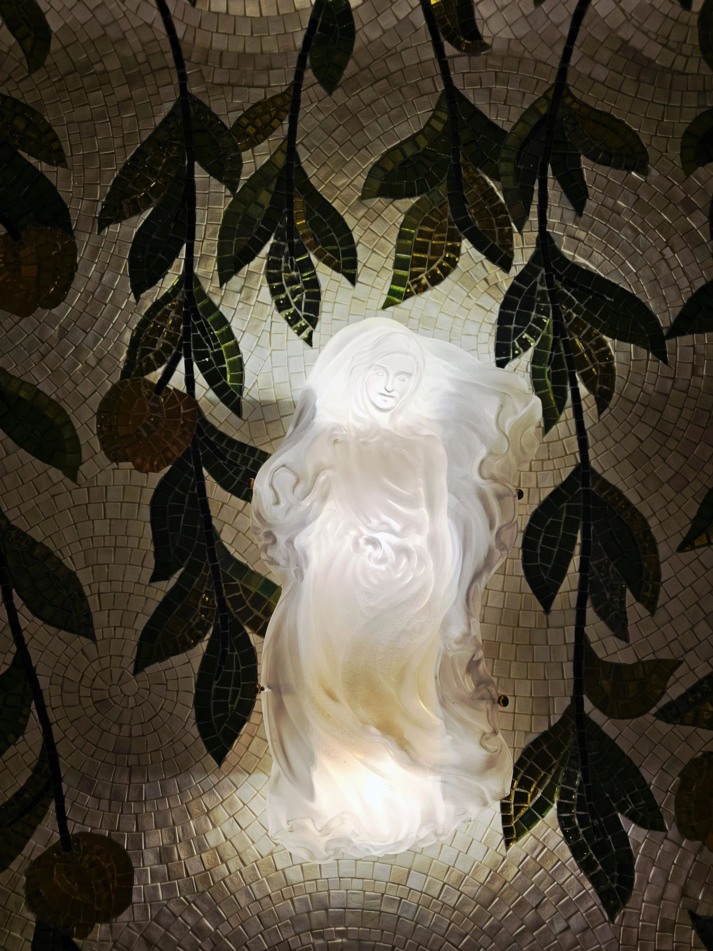 Sculpture of Venus on mosaic wall