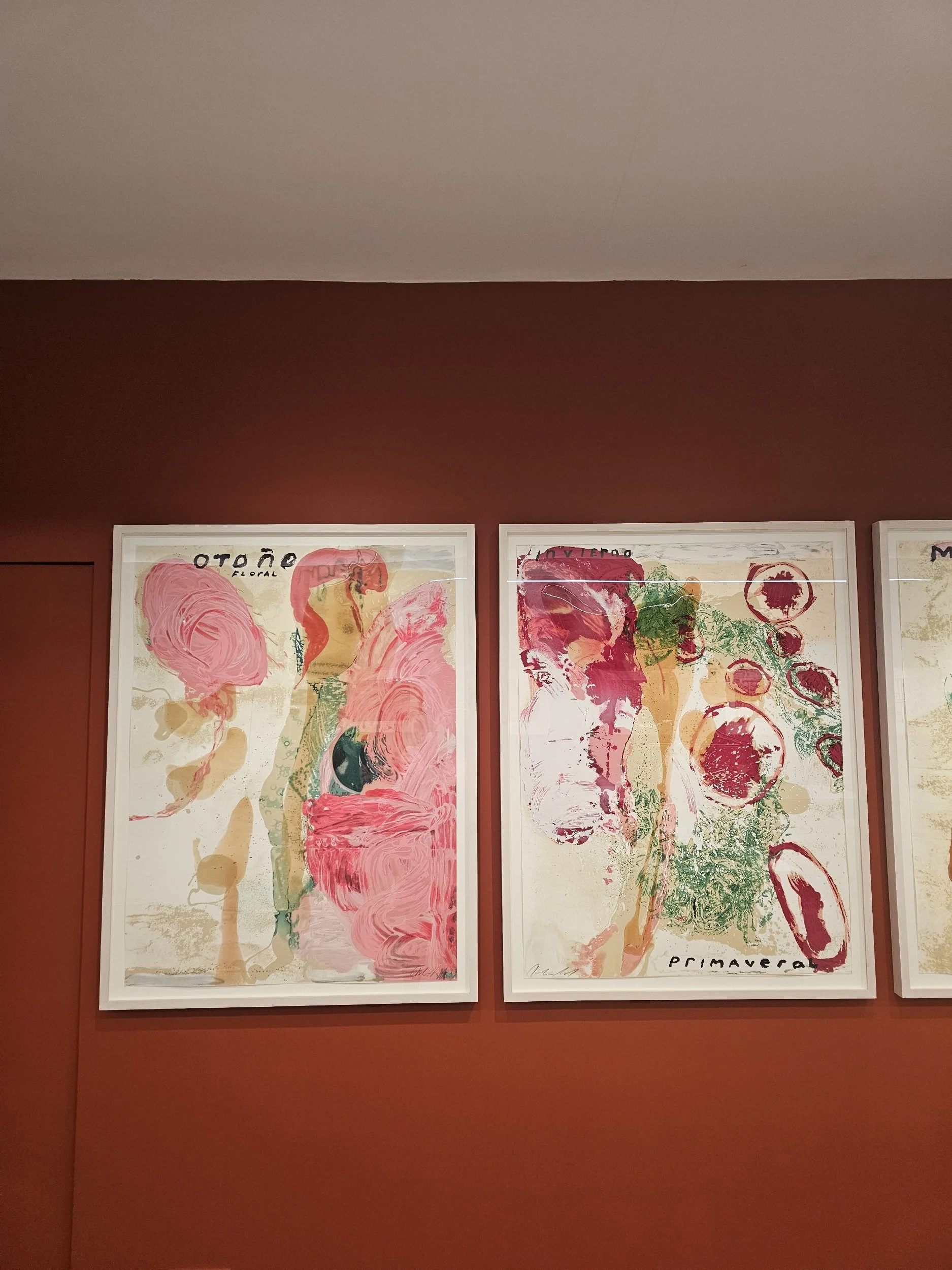 Art hung on red wall