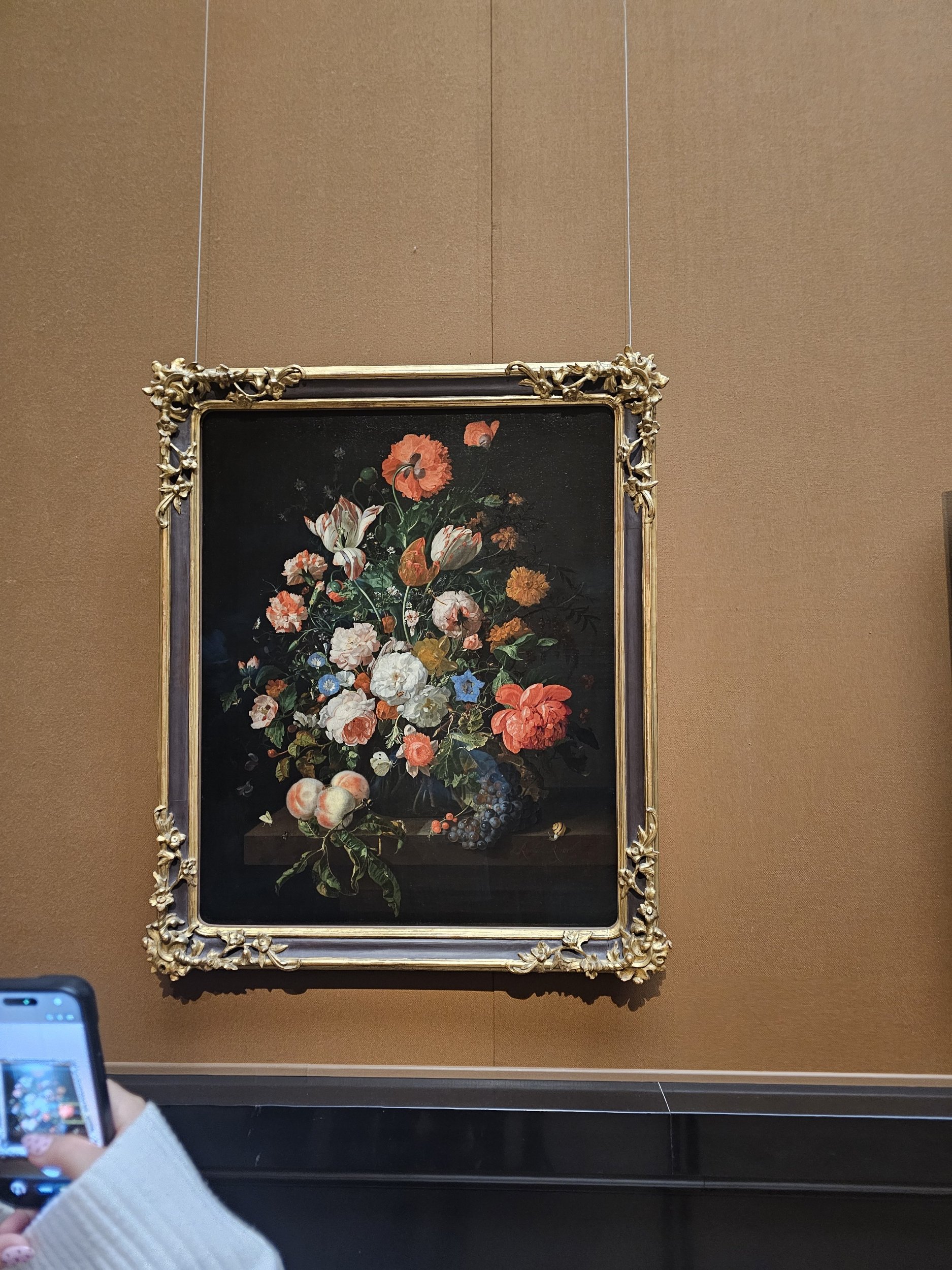 Flowers still life with a bowl of fruit and oysters by Rachel Ruysch