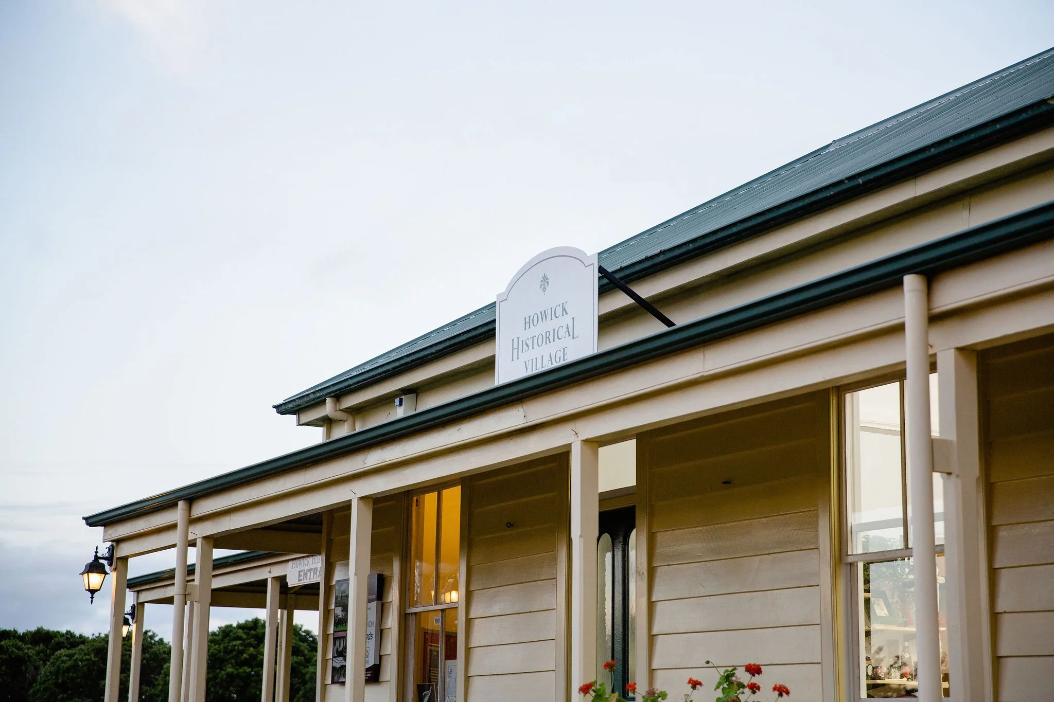 Building of Howick Historical Village with signage, porch, and windows.