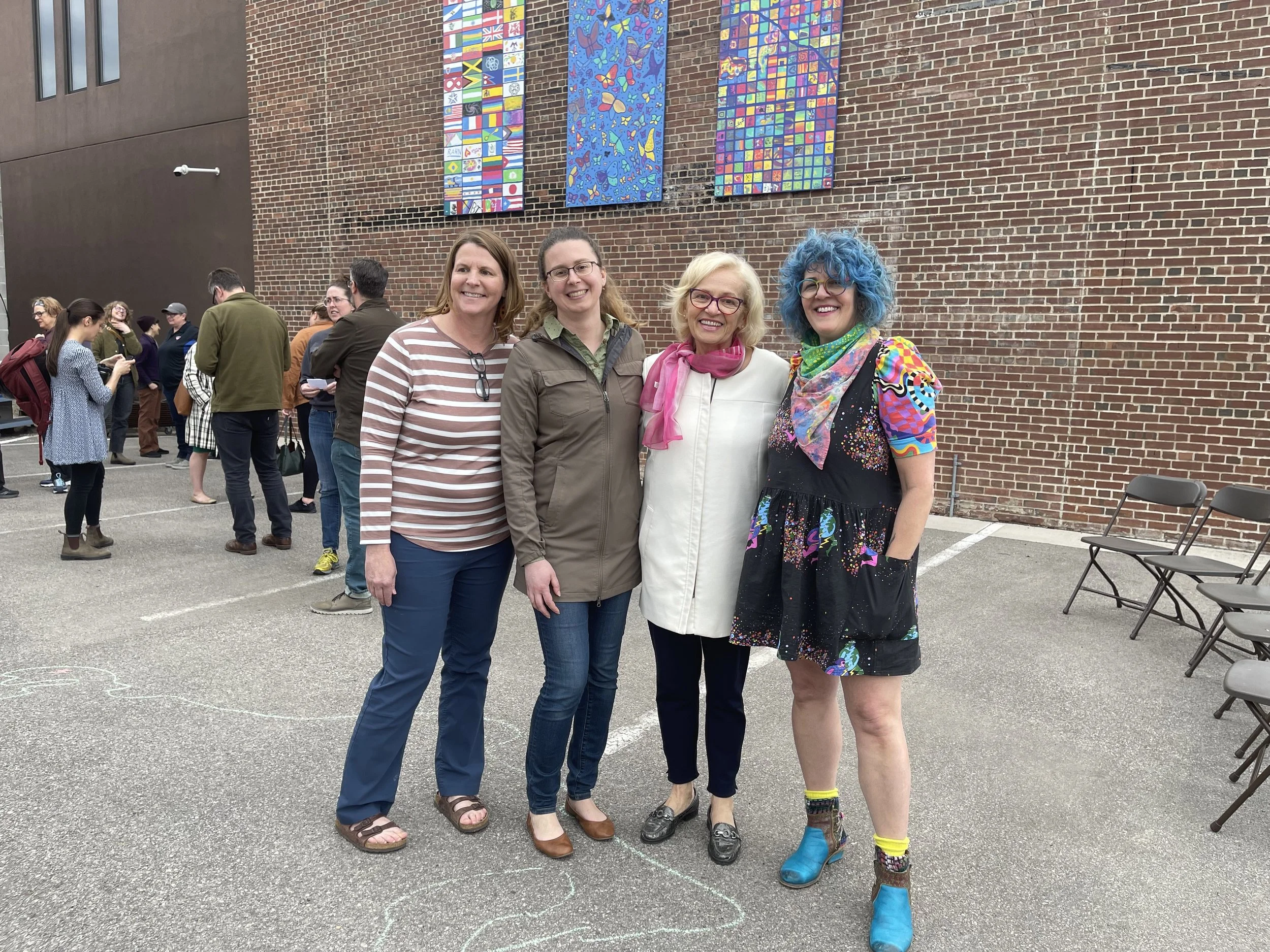 Winona County History Center Director Carrie Johnson, Winona County History Center Educator Jennifer Weaver, Project FINE Executive Director Fatima Said, Community Engaged Artist Sarah Johnson at the mural unveiling May 5, 2022.