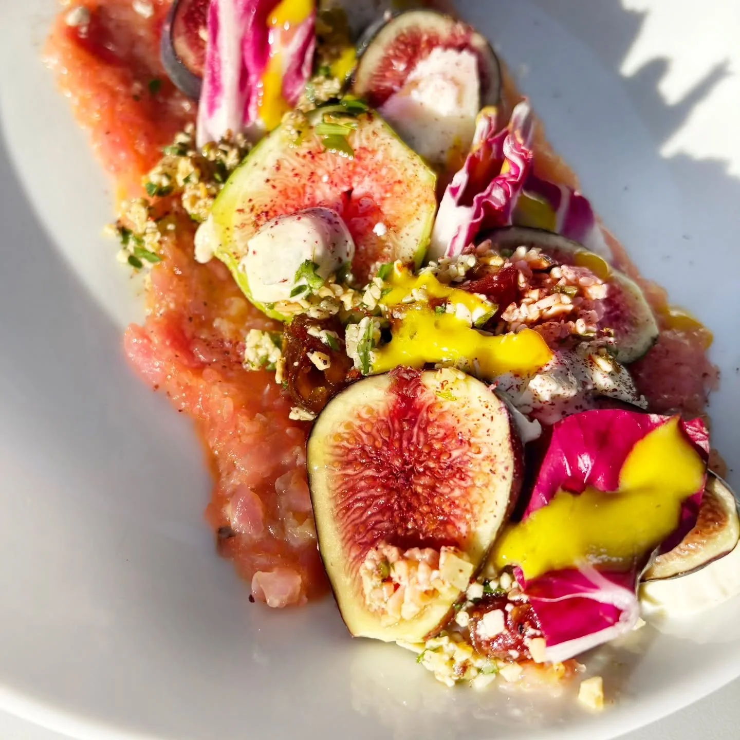This new beauty on the block is our fig salad. Goodness it's gorgeous! Locally grown figs, aged goat cheese, chicories, dates, walnuts, almonds, and apricot vinaigrette all on a bed of crushed candy striped beets. ✨
.
.
(Thank you cousin darrel for y